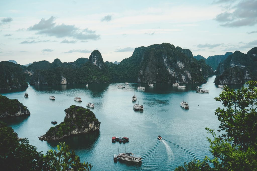An arial photo of Vietnamese cliffs and ocean with boats